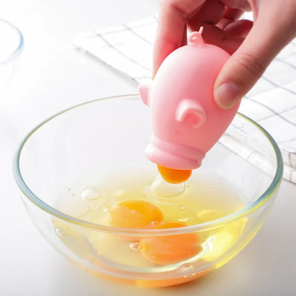 Pink silicone egg divider separating yolk in bowl